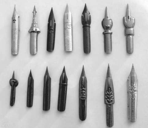 A collection of pointed metal nibs with different shapes and sizes.