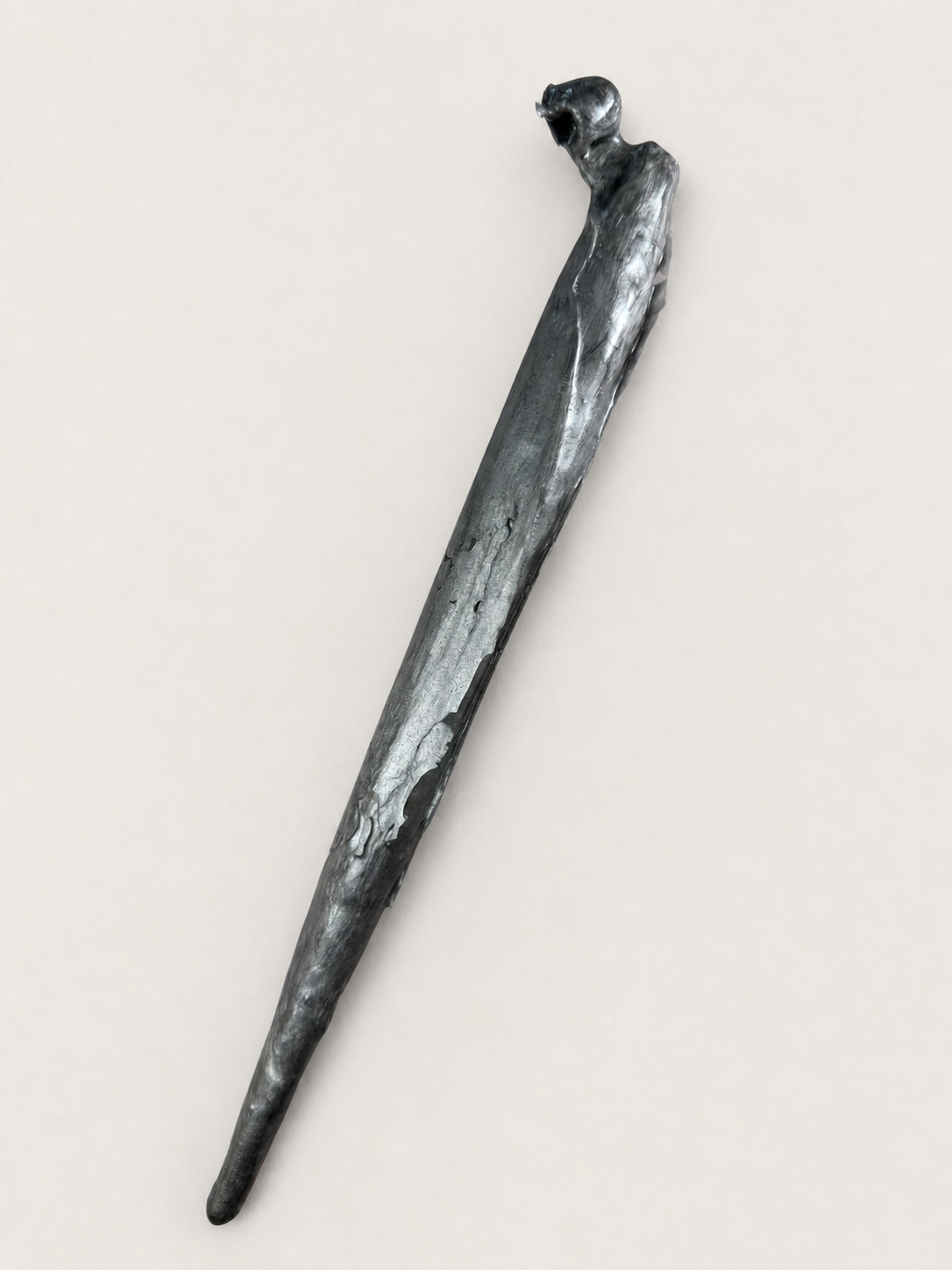 Early rough oblique calligraphy pen holder prototype on a warm neutral background
