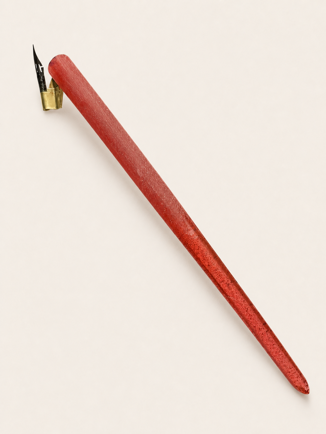 Red flat-bodied oblique holder prototype, angled view showing body and flange
