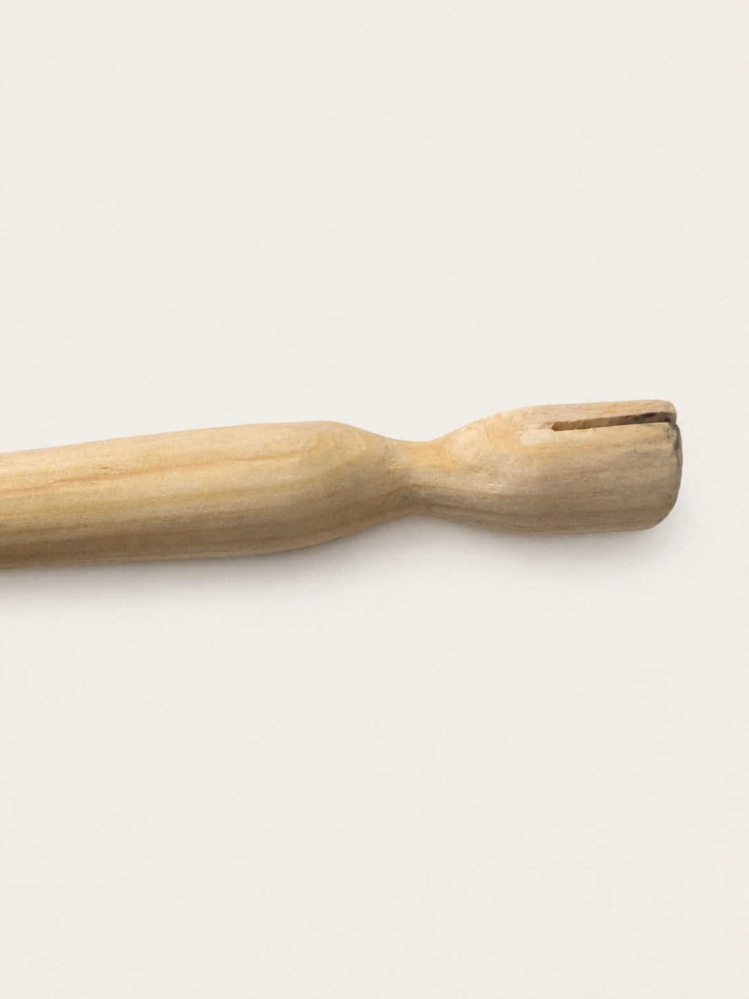Side detail of a hand-carved wooden holder body showing the flange slot