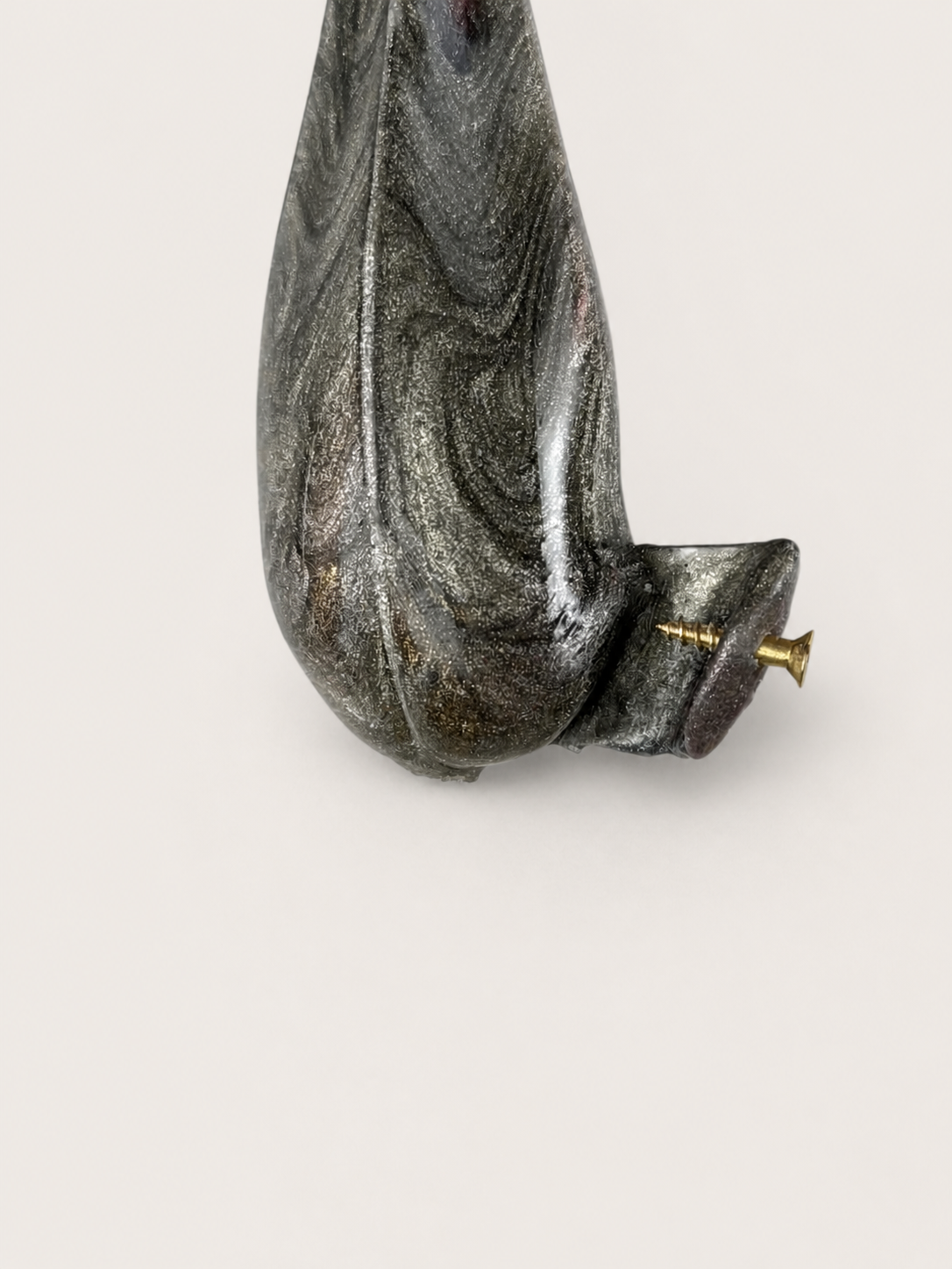 Close detail of the screwed head system on a marbled oblique holder prototype